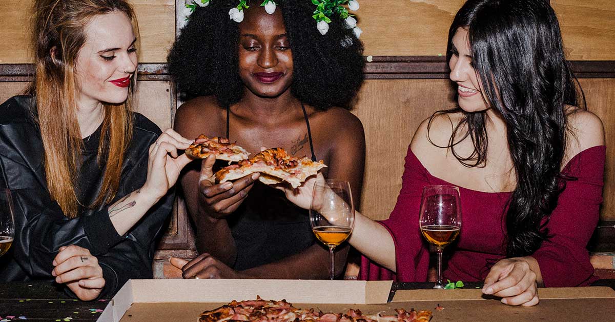 friends sharing pizza--The Ivy popup pub